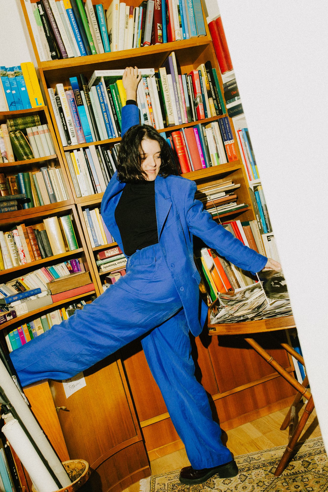 In a second-hand bookshop in a blue suit