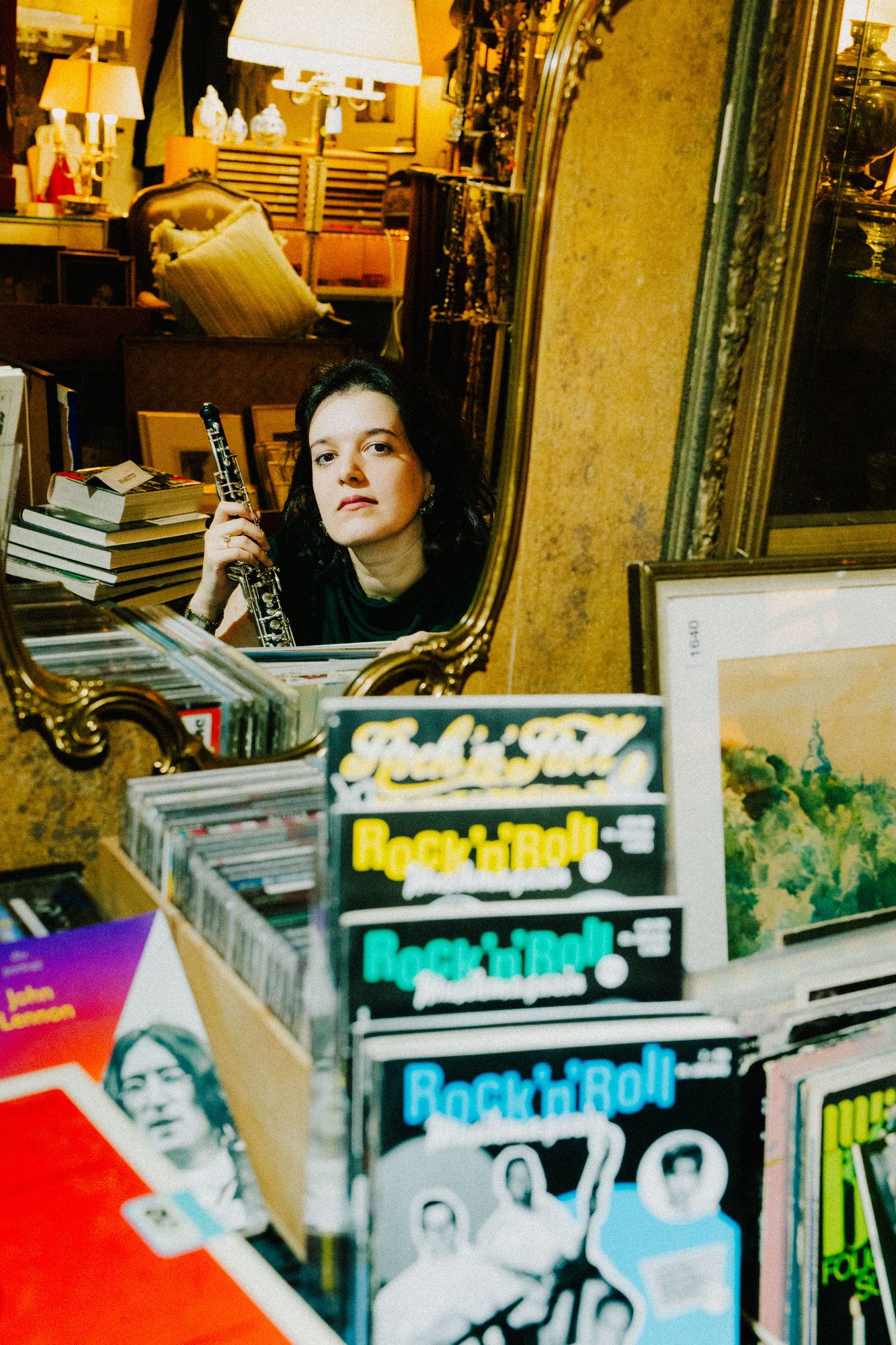 Reflected in a mirror above crates of records