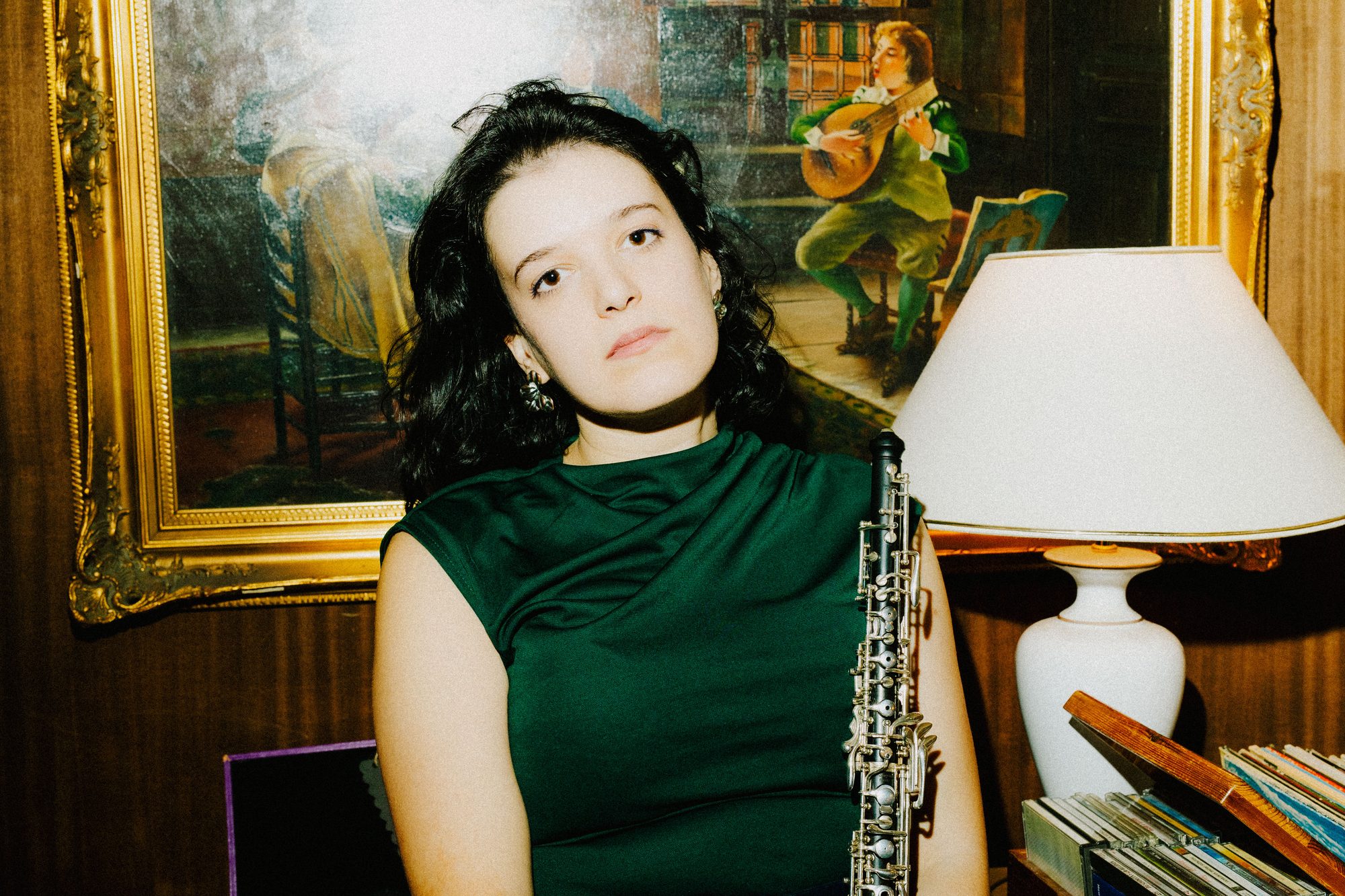 Seated with the oboe in front of a gilt painting
